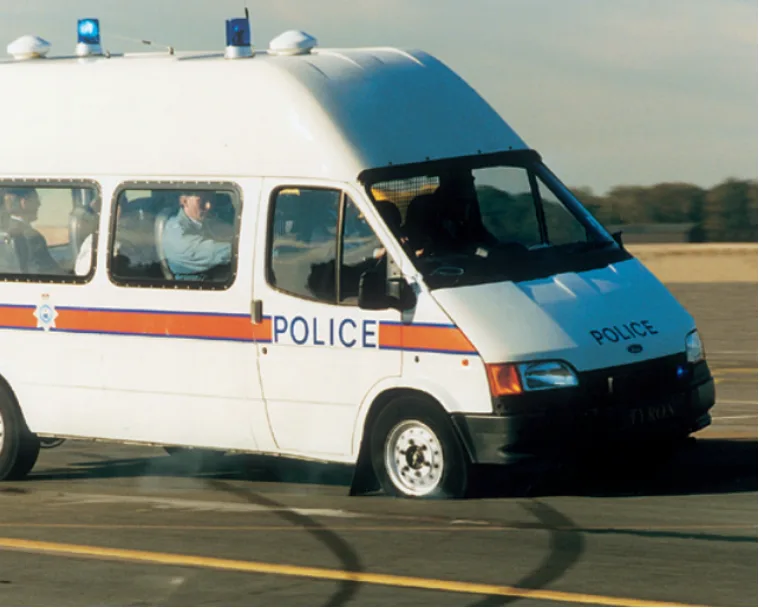 Police van on a test track with a deflated tyre, still steering under control